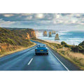 Coastal road trip artwork with vintage car and ocean cliffs for modern living room decor.