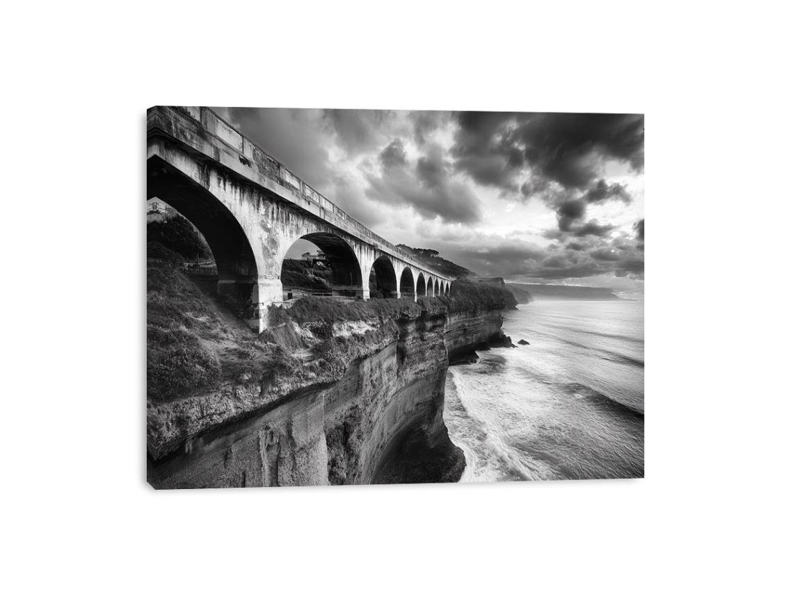 Black and white coastal bridge photography for moody modern office wall decor.