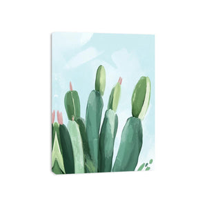 Soft green cactus canvas art with pale blue sky for modern bedroom decor.