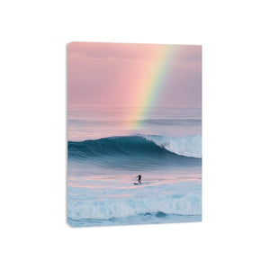 Rainbow ocean wave canvas art with surfer for dreamy coastal bedroom decor.