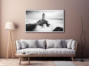 Black and white lighthouse photography wall art with storm waves for modern office decor.