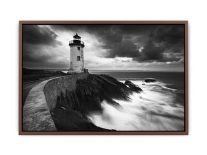 Moody black and white lighthouse wall art with storm clouds for modern living room decor.