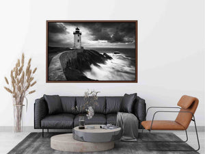 Moody black and white lighthouse wall art with storm clouds for modern living room decor.