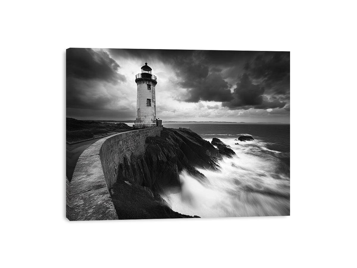 Moody black and white lighthouse wall art with storm clouds for modern living room decor.