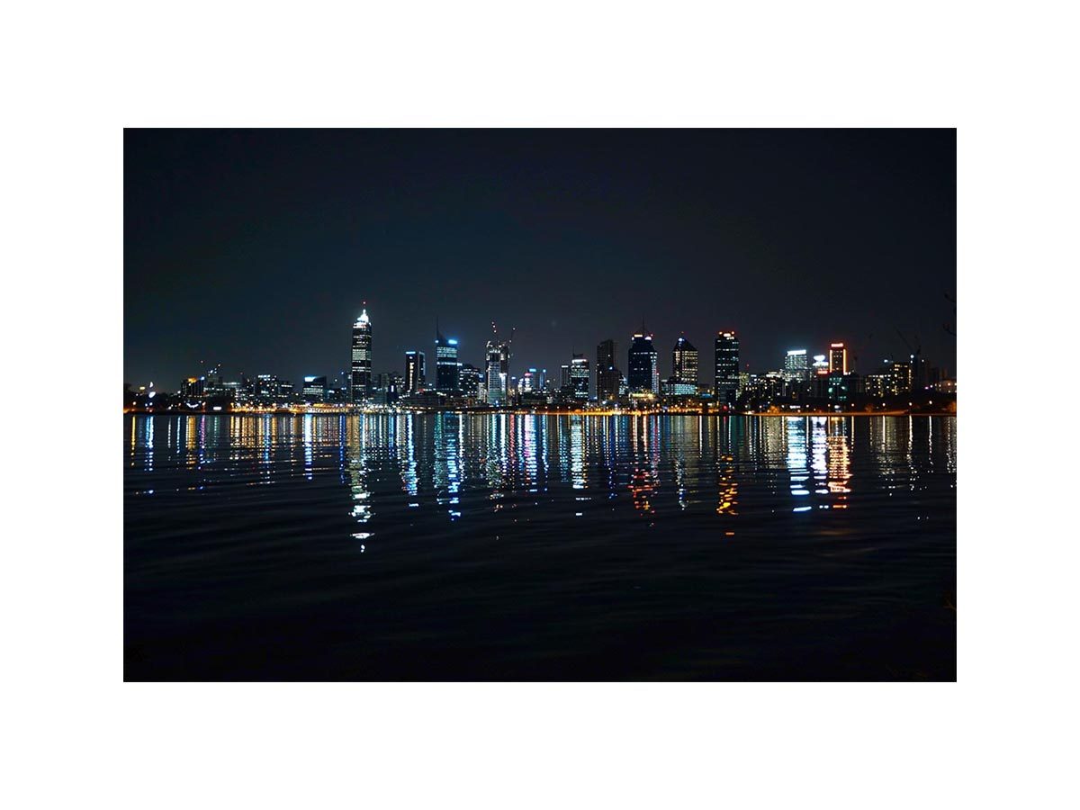 Night city skyline artwork with reflections for modern office decor.