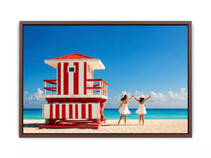 Minimal coastal beach scene with red lifeguard hut blue ocean and two women walking aesthetic wall art