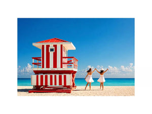 Minimal coastal beach scene with red lifeguard hut blue ocean and two women walking aesthetic wall art