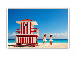 Minimal coastal beach scene with red lifeguard hut blue ocean and two women walking aesthetic wall art