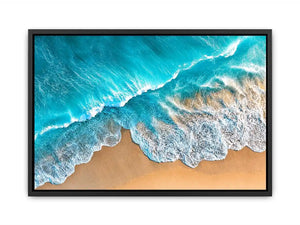 Aerial turquoise ocean beach canvas print with white foamy waves washing over sandy shore and tropical coastal water view