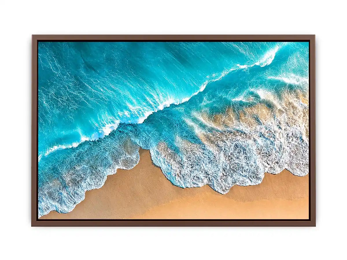 Aerial turquoise ocean beach canvas print with white foamy waves washing over sandy shore and tropical coastal water view