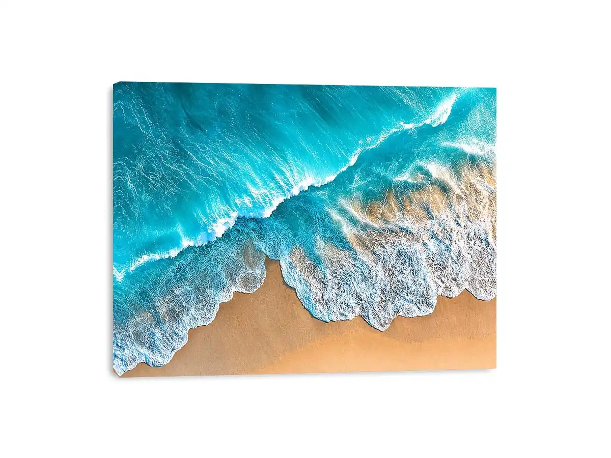 Aerial turquoise ocean beach canvas print with white foamy waves washing over sandy shore and tropical coastal water view