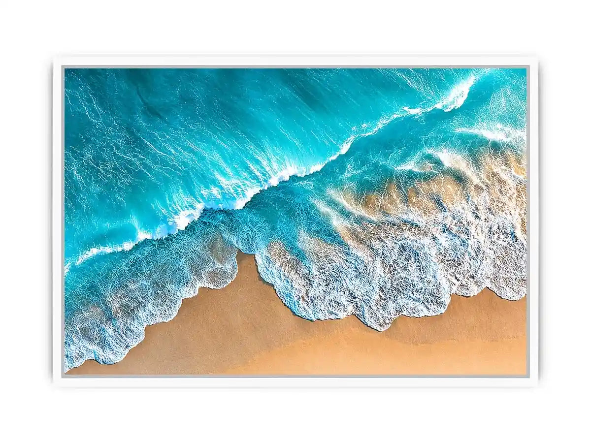 Aerial turquoise ocean beach canvas print with white foamy waves washing over sandy shore and tropical coastal water view