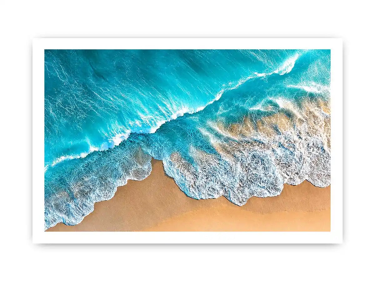 Aerial turquoise ocean beach canvas print with white foamy waves washing over sandy shore and tropical coastal water view