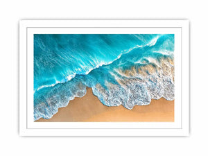 Aerial turquoise ocean beach canvas print with white foamy waves washing over sandy shore and tropical coastal water view