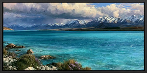 Teal alpine lake canvas print with snow mountains and dramatic clouds for refined living room or bedroom decor.