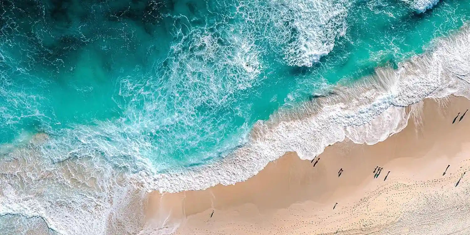 Aerial turquoise beach canvas art with ocean foam for modern coastal decor.