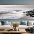 Neutral black and white coastal canvas art with rocks for calming bedroom decor.