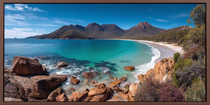 Turquoise coastal bay canvas art with mountains for modern beach house decor.