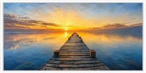 Sunset pier canvas print with calm water, wooden jetty and glowing horizon.