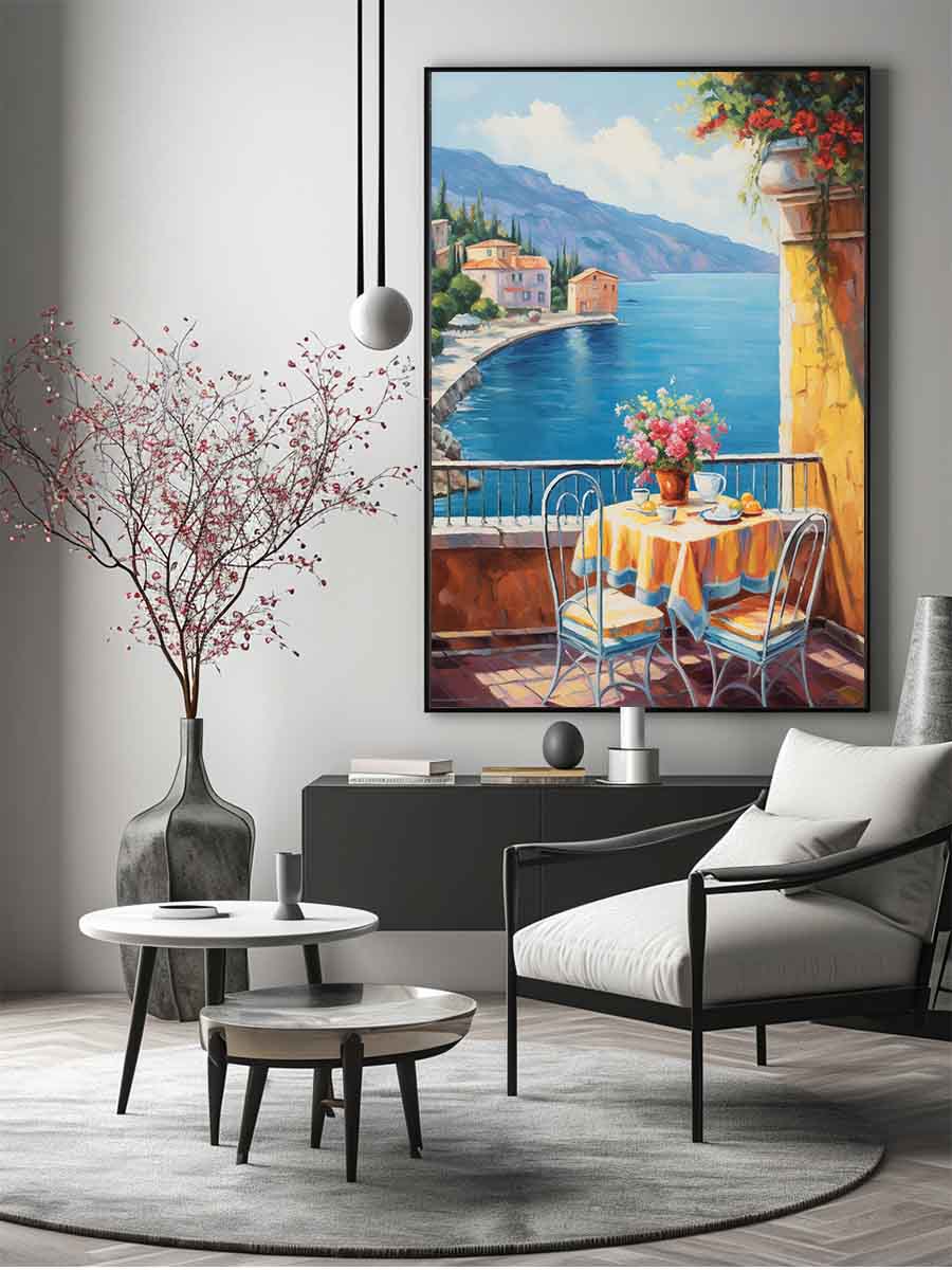 Mediterranean balcony canvas art with blue sea, yellow table, flowers, and coastal village view.