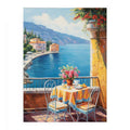 Mediterranean balcony canvas art with blue sea, yellow table, flowers, and coastal village view.