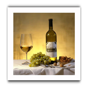 White wine bottle grapes and glass still life for dining room decor.