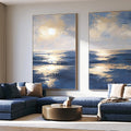 Blue and gold ocean canvas art with sunlit waves for luxury living room decor.