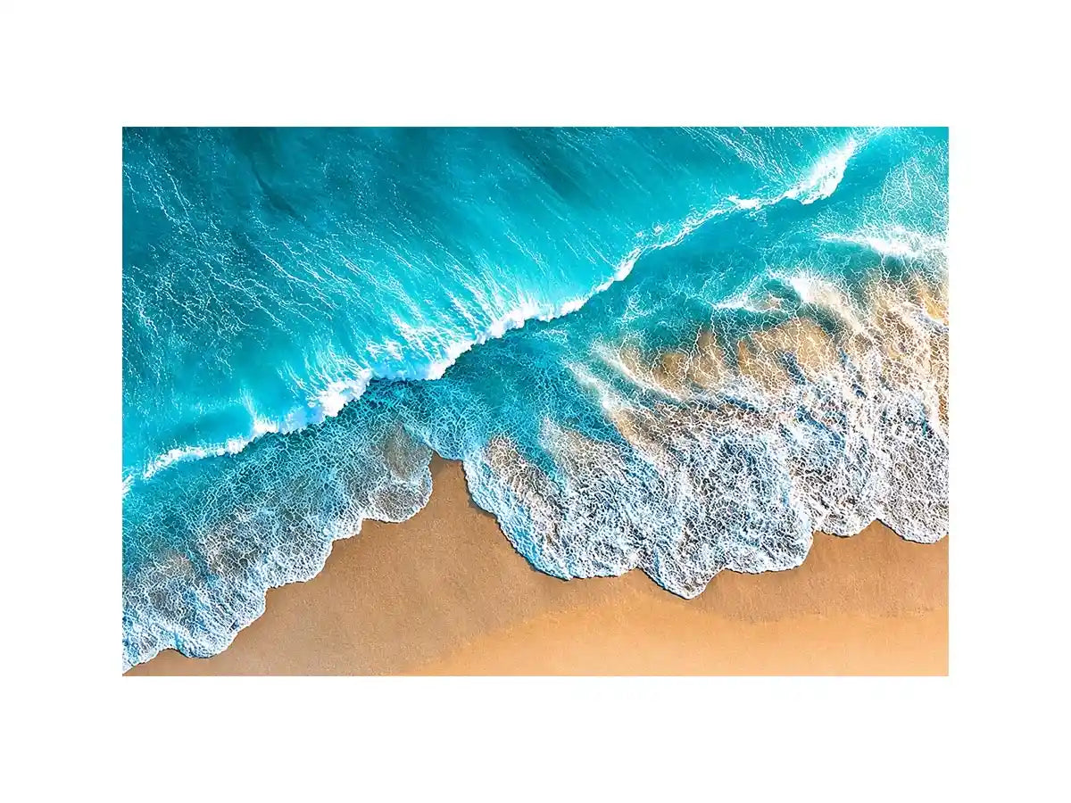 Aerial turquoise ocean beach canvas print with white foamy waves washing over sandy shore and tropical coastal water view