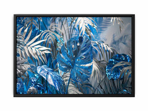 Blue tropical leaf canvas art with silver palm foliage for glamorous modern wall decor.