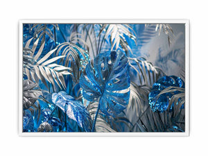 Blue tropical leaf canvas art with silver palm foliage for glamorous modern wall decor.