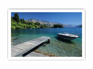 Mountain lake canvas art with dock, boat and clear blue water for modern interiors.