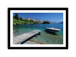 Mountain lake canvas art with dock, boat and clear blue water for modern interiors.