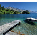 Mountain lake canvas art with dock, boat and clear blue water for modern interiors.