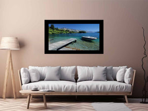 Mountain lake canvas art with dock, boat and clear blue water for modern interiors.