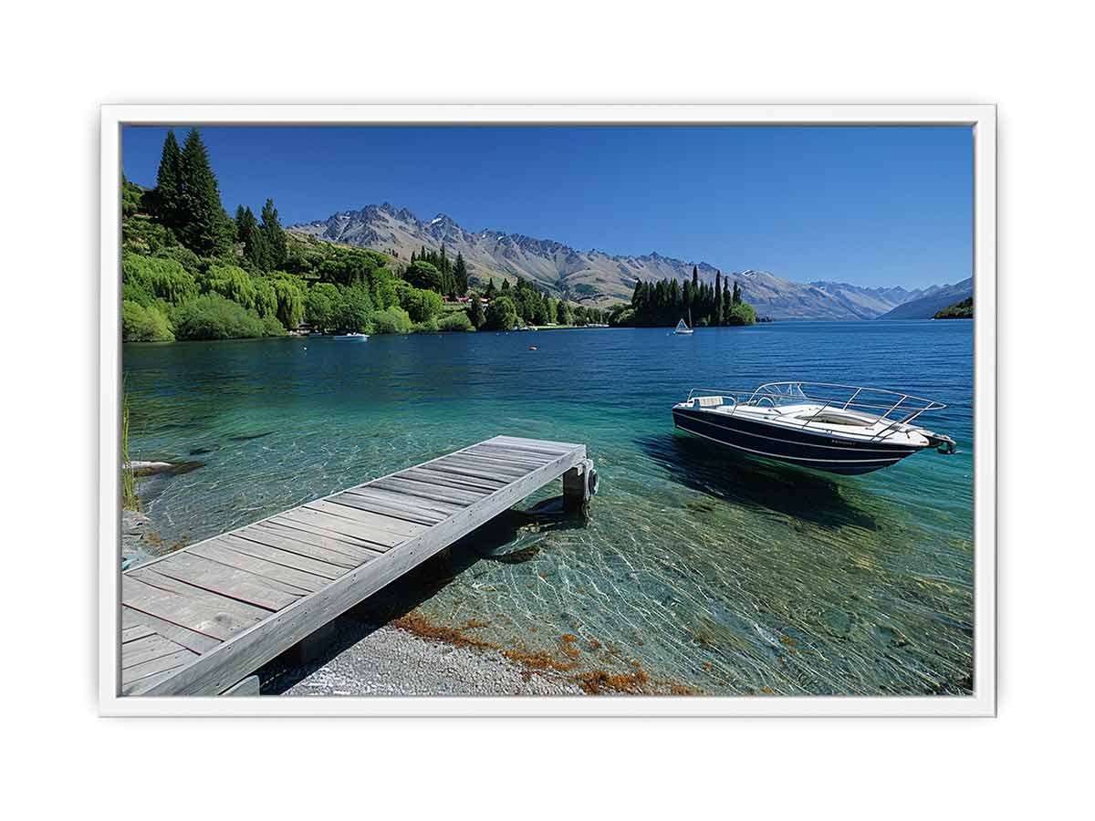 Mountain lake canvas art with dock, boat and clear blue water for modern interiors.