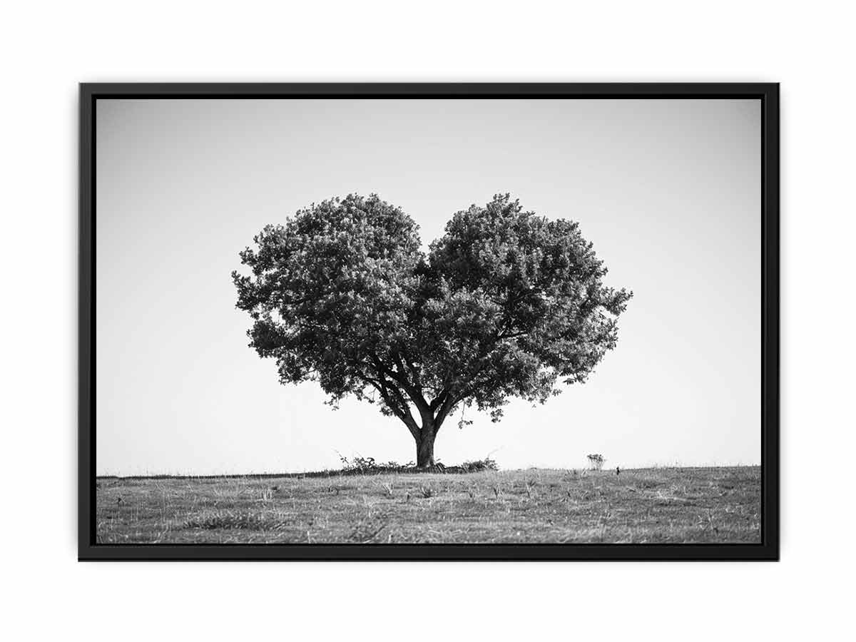 Black and white lone heart-shaped tree canvas art for minimalist room decor.