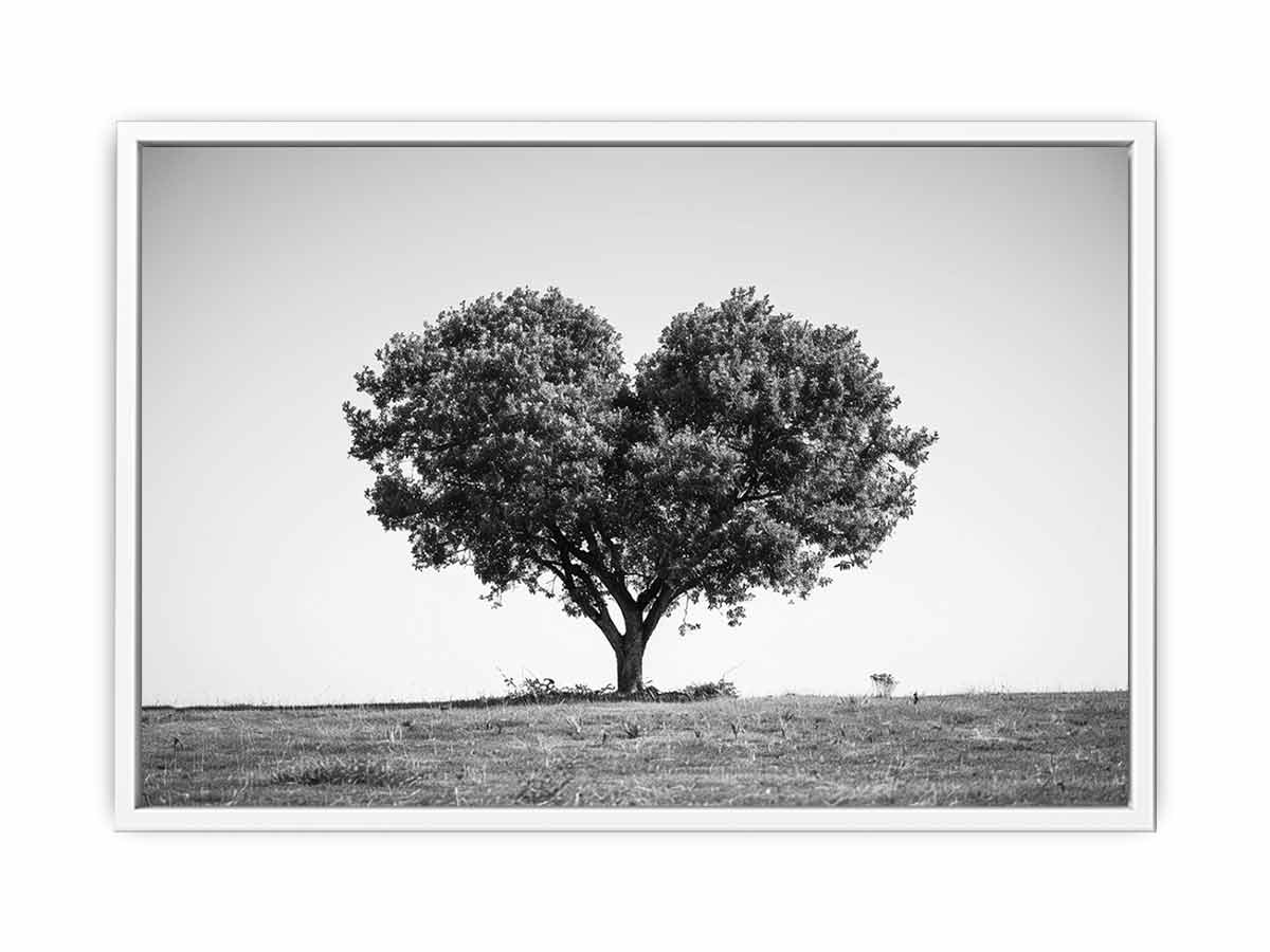Black and white lone heart-shaped tree canvas art for minimalist room decor.