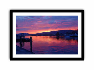 Sunset lake harbor canvas print with mountains and reflections for serene living room decor.