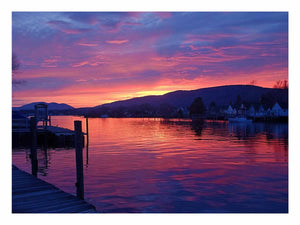 Sunset lake harbor canvas print with mountains and reflections for serene living room decor.