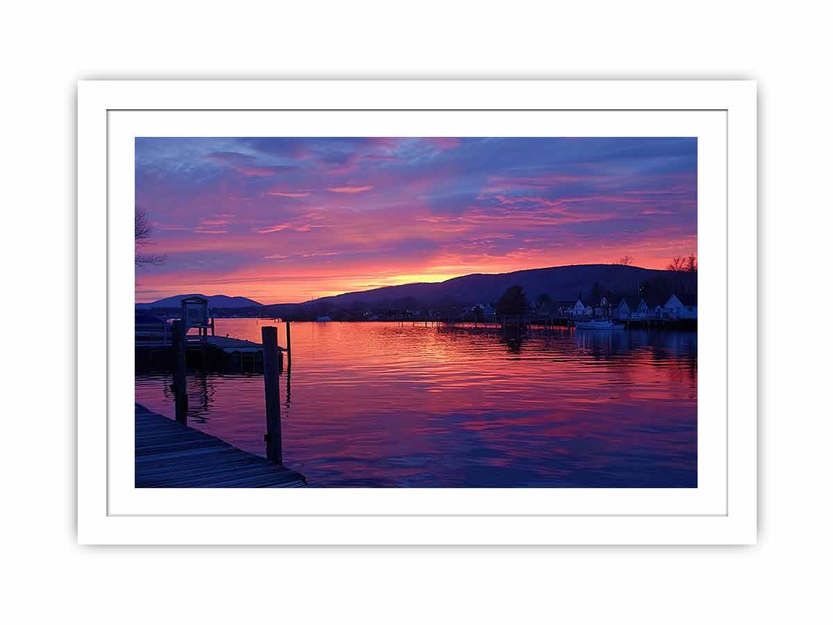 Sunset lake harbor canvas print with mountains and reflections for serene living room decor.