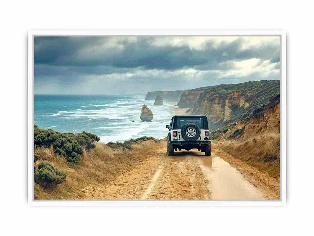 Off-road vehicle on a coastal dirt track overlooking turquoise waves, limestone sea stacks and golden cliffs beneath a cloudy sky