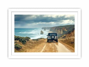 Off-road vehicle on a coastal dirt track overlooking turquoise waves, limestone sea stacks and golden cliffs beneath a cloudy sky