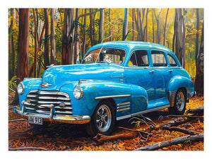 Blue vintage car canvas art in forest setting for office or man cave decor.