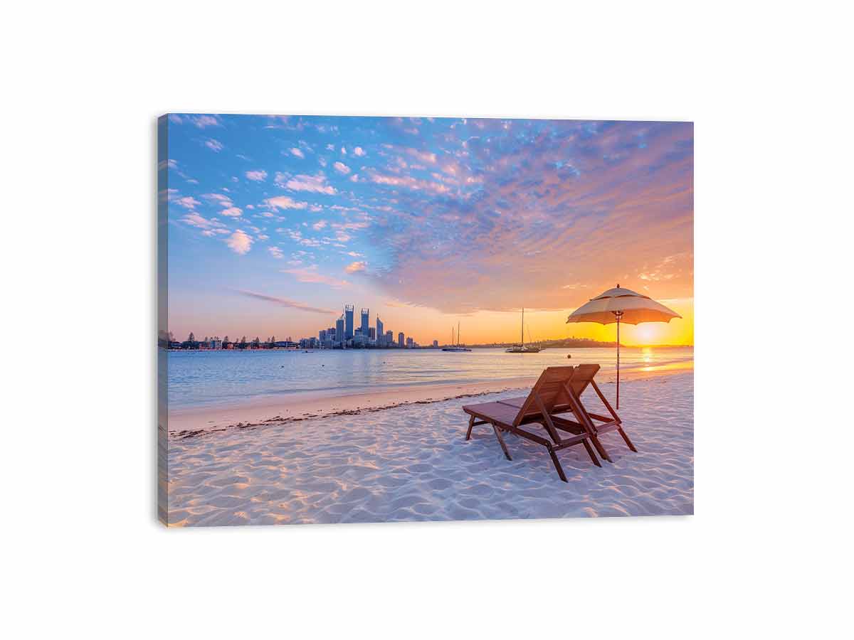 Coastal sunset canvas art with beach chairs and city skyline for relaxed living room decor.