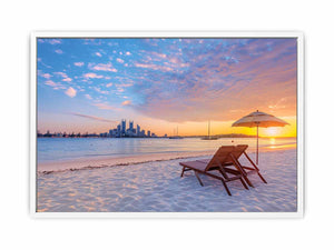 Coastal sunset canvas art with beach chairs and city skyline for relaxed living room decor.