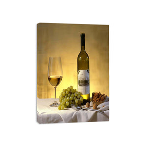 White wine bottle grapes and glass still life for dining room decor.