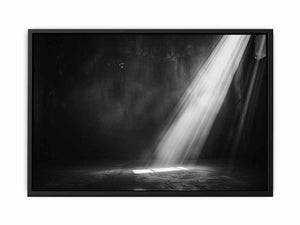 Dramatic black and white light beam entering a dark industrial room for modern living rooms decor.