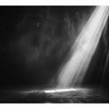 Dramatic black and white light beam entering a dark industrial room for modern living rooms decor.