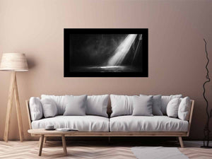 Dramatic black and white light beam entering a dark industrial room for modern living rooms decor.