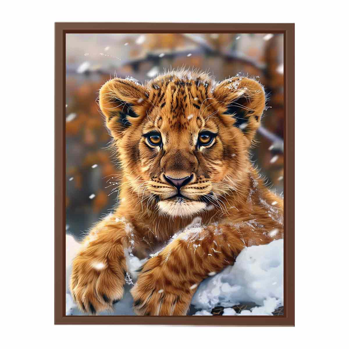 Young lion cub resting in snow with soft falling flakes for modern nurseries decor.